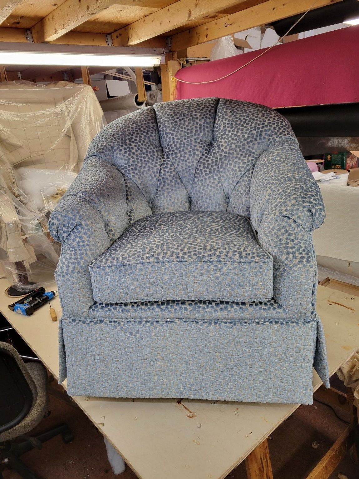 A Blue Chair Sitting On A Table — Upholstery in Danvers, MA