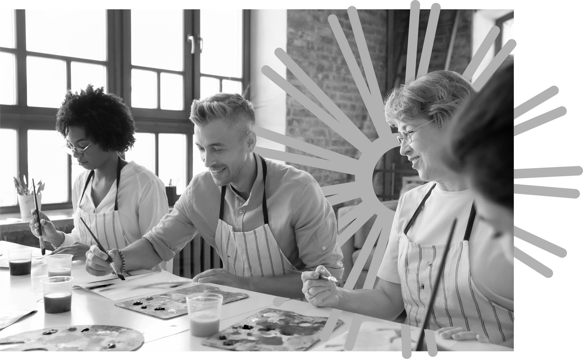 A group of older people are sitting at a table painting.