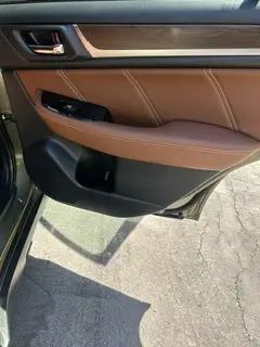 A close up of a car door with the door open.