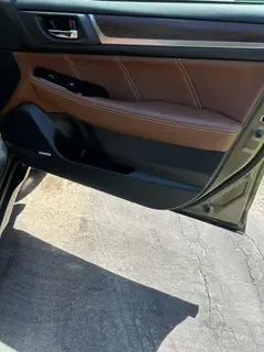 A close up of a car door with the door open.