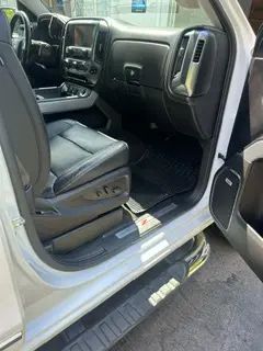 The interior of a white truck with the door open.