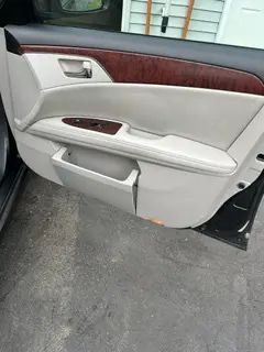 A close up of a car door with the door open.