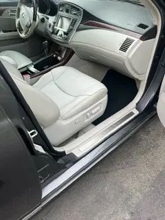 The inside of a car with the door open and the seats up.