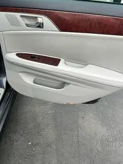 A close up of a car door with the door open.