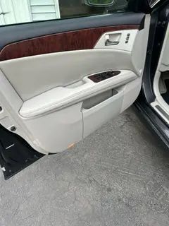 A close up of a car door with the door open.