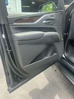 A close up of a car door with the door open.