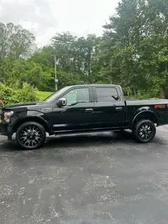 A black pickup truck is parked in a parking lot.