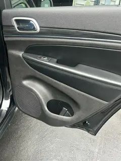The back door of a jeep grand cherokee with the door open.