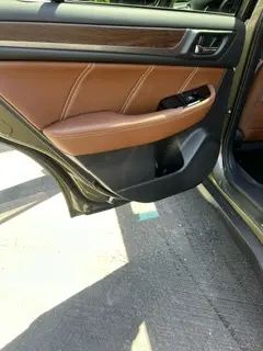 A close up of a car door with the door open.