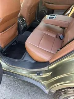 The back seat of a car with brown leather seats.