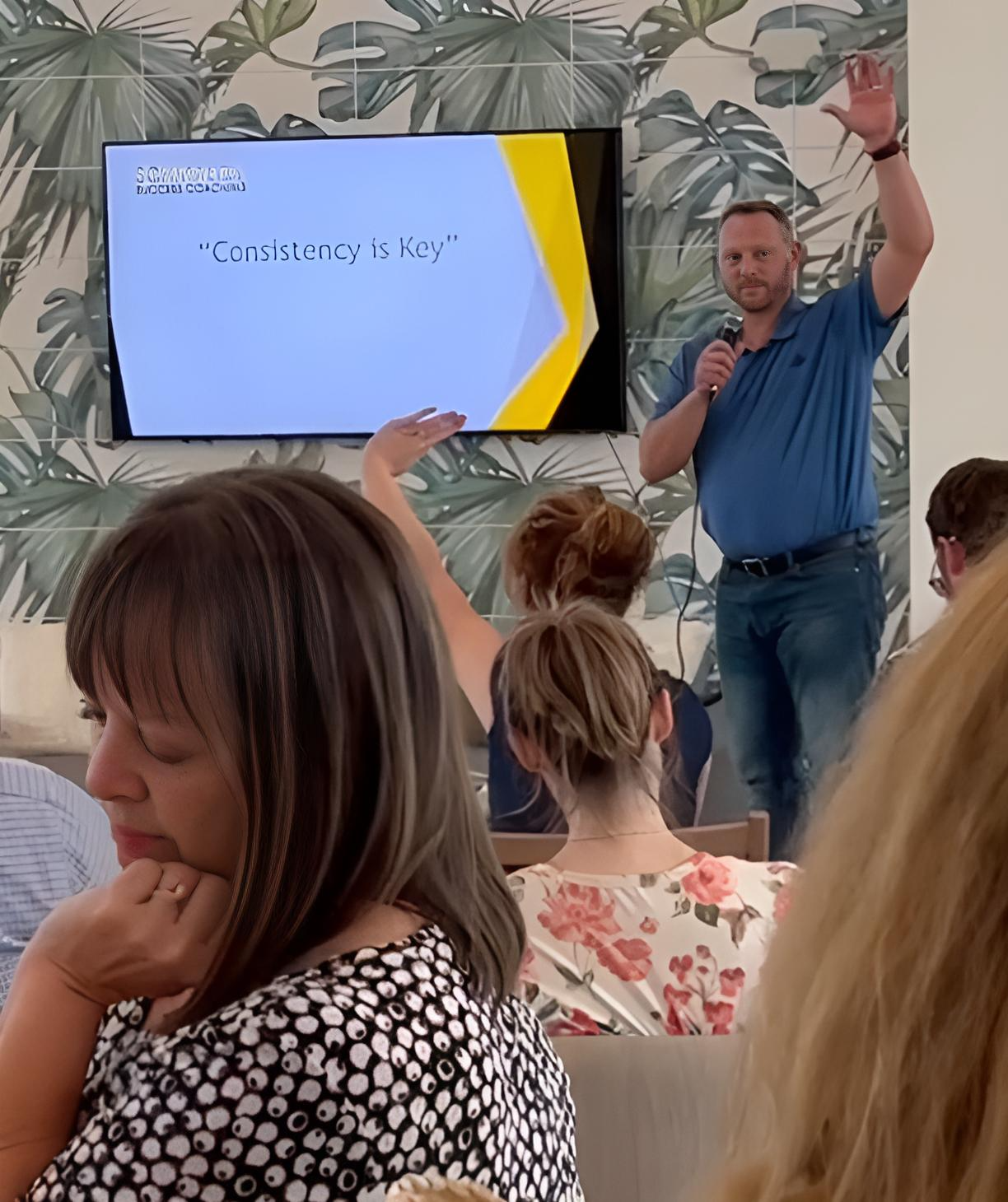 A man is giving a presentation to a group of people