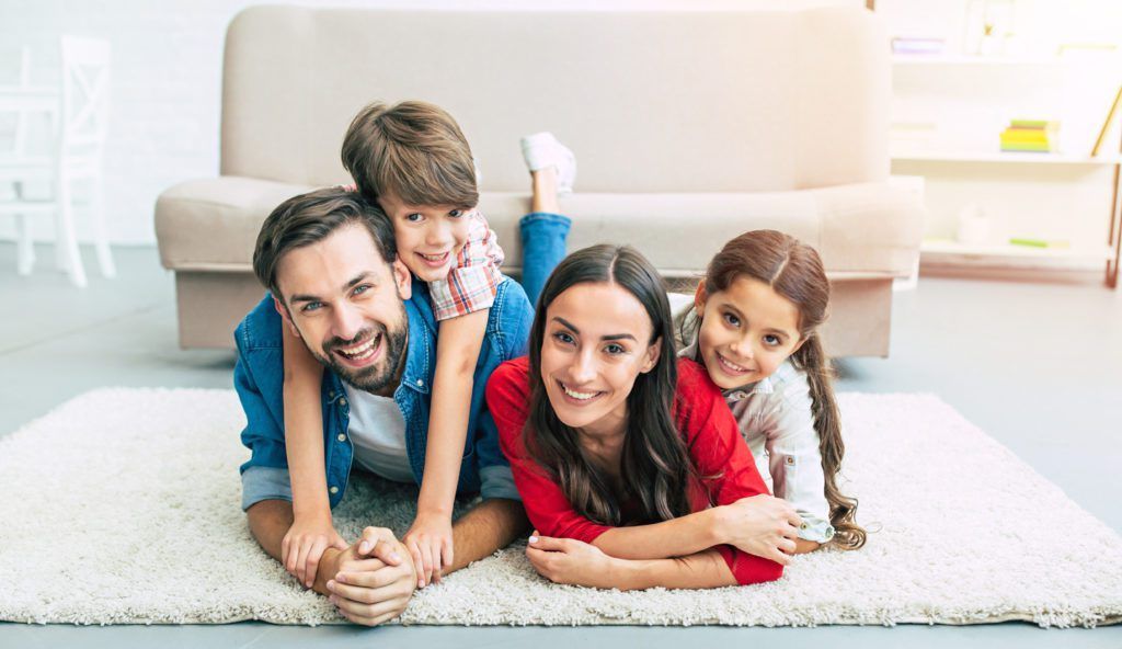 family smiles knowing they are protected by life insurance