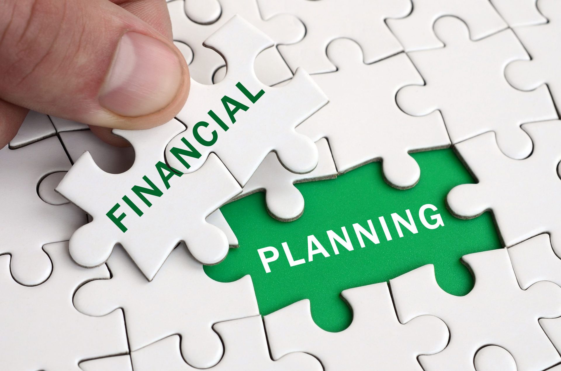 close up of puzzle pieces that say financial planning