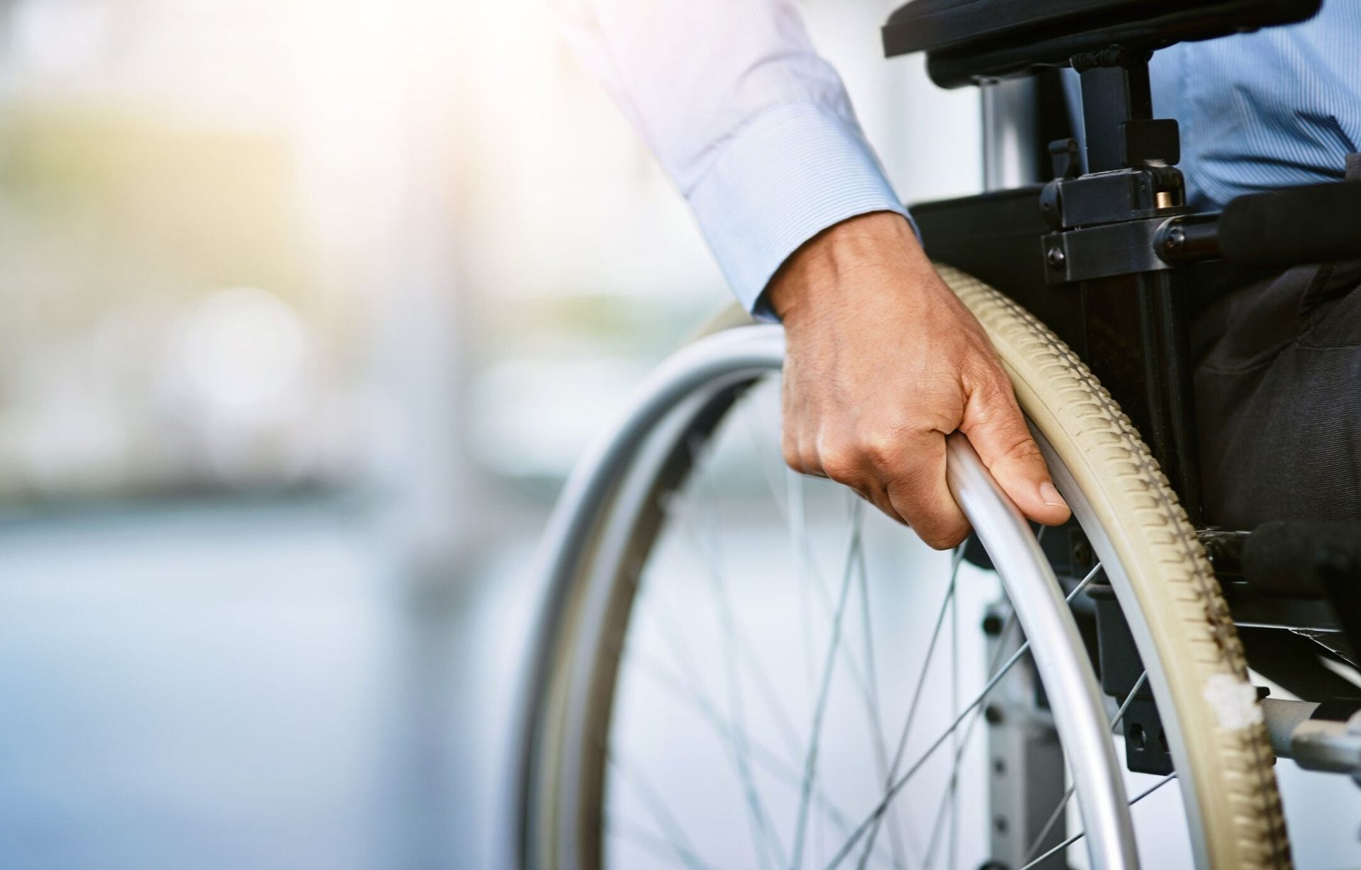 close up of a hand on a wheelchair representing disability insurance