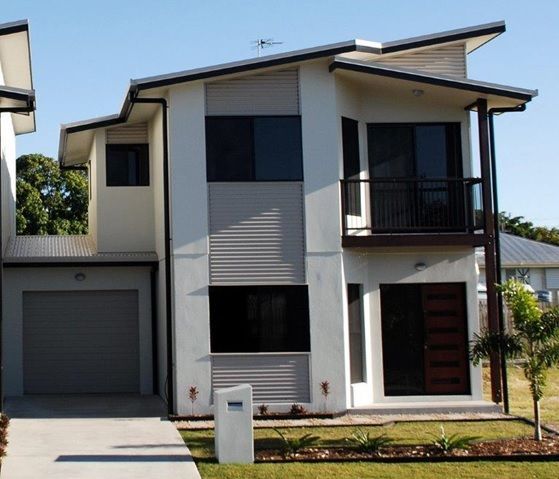 A White House With A Garage And A Mailbox In Front Of It — Integrabuild in Bowen, QLD