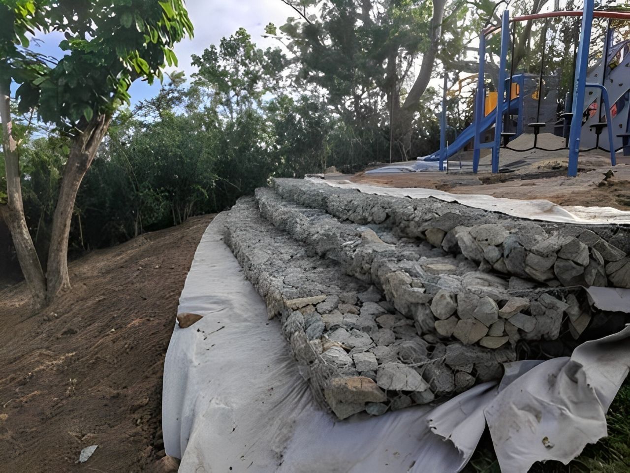 A stack of rocks sits in front of a playground — Integrabuild in Bowen, QLD