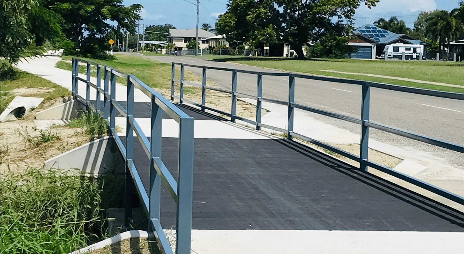 A bridge over a road with a blue railing — Integrabuild in Bowen, QLD