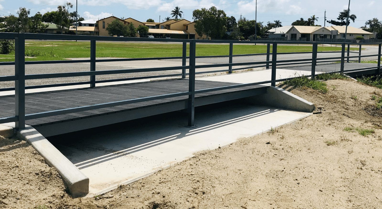 A metal bridge with a concrete ramp and a metal railing — Integrabuild in Bowen, QLD