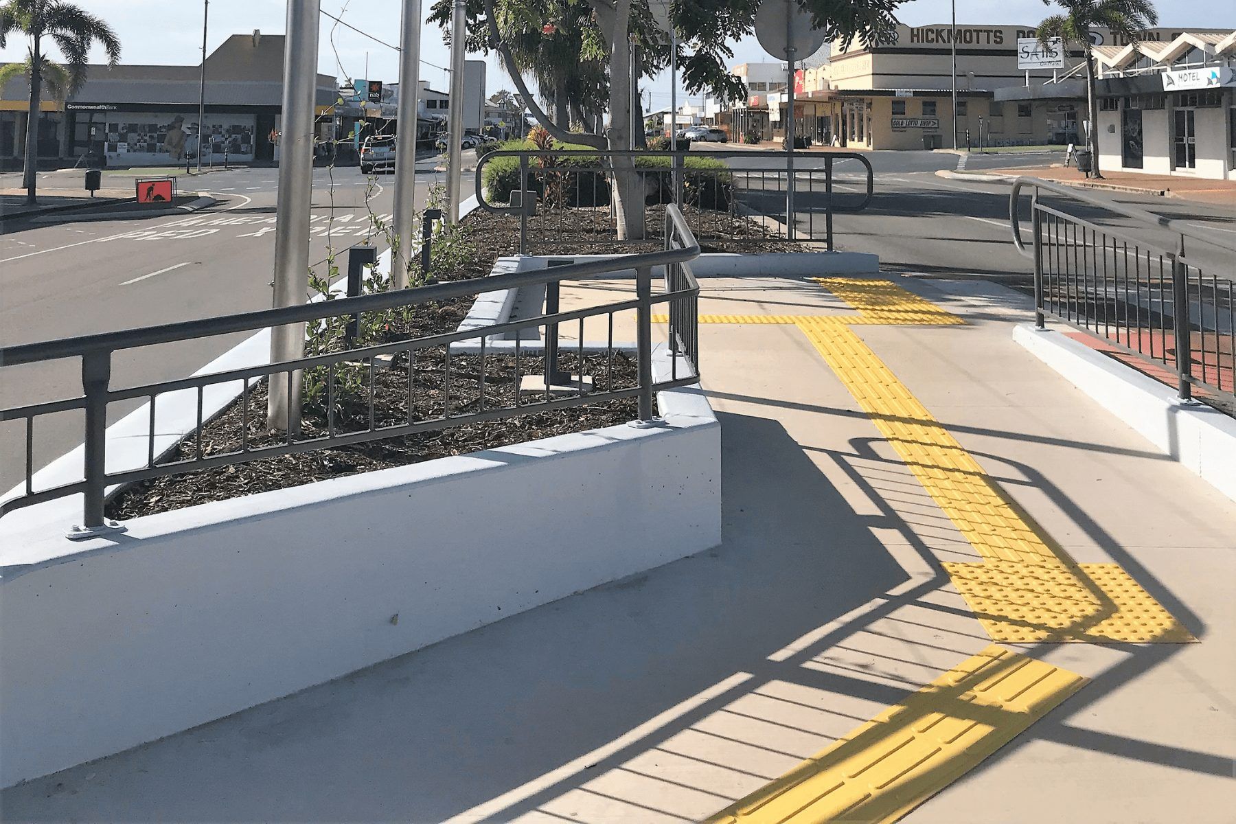 A concrete walkway with a railing and a yellow curb — Integrabuild in Bowen, QLD
