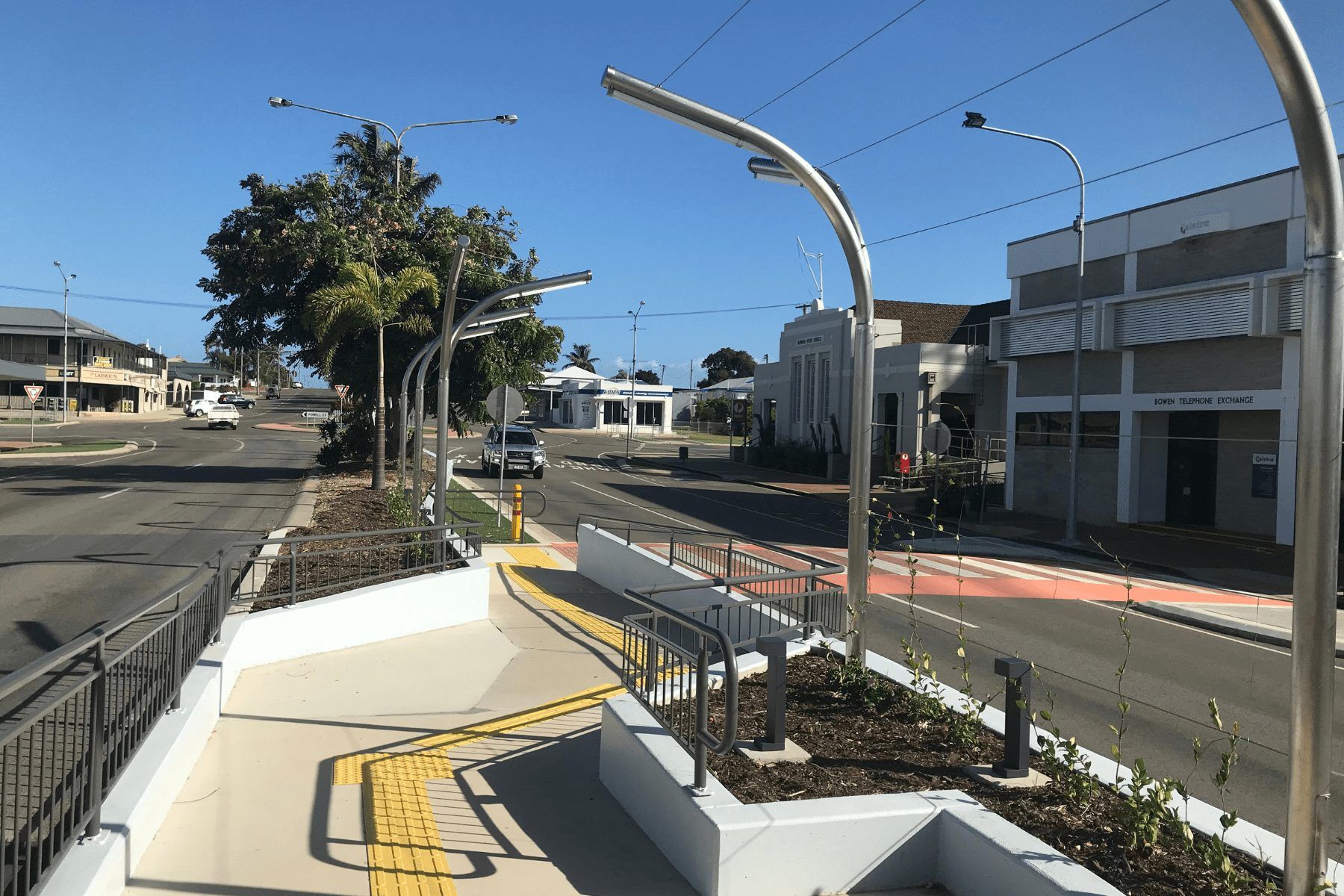 A street with a bench and a fence on the side of it — Integrabuild in Bowen, QLD