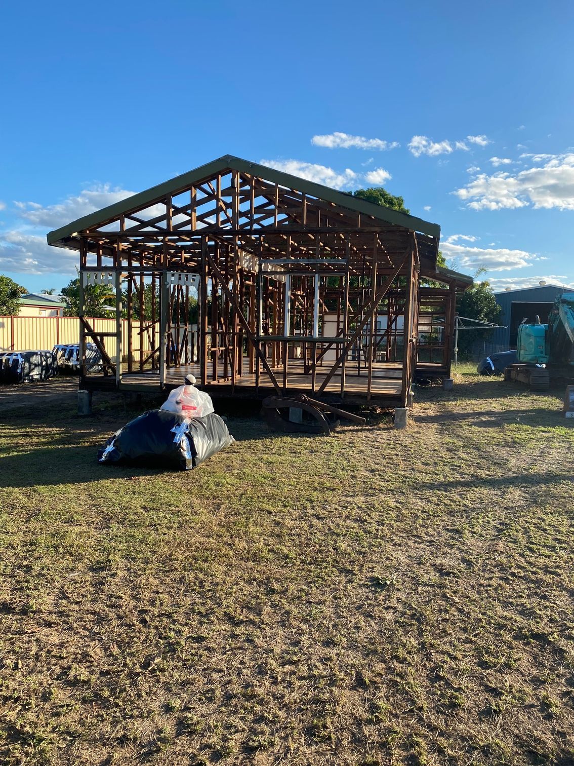 Wooden house frame under construction, outdoors on a sunny day — Integrabuild in Airlie Beach, QLD