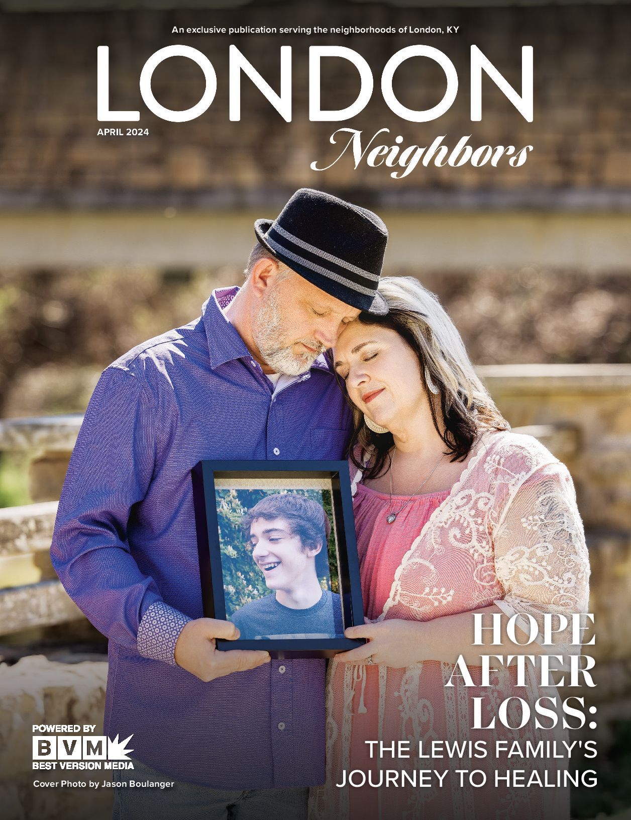 Couple holding framed photo, leaning in, outside. Cover for 