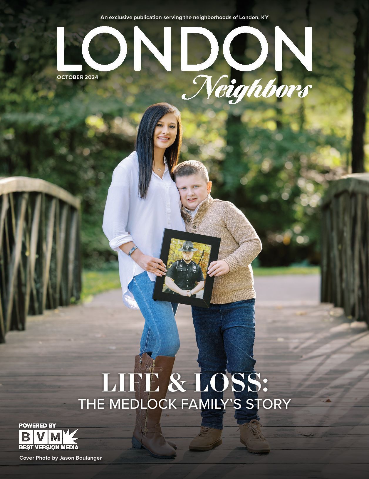 Woman and boy on a bridge, holding a framed photo; cover of 