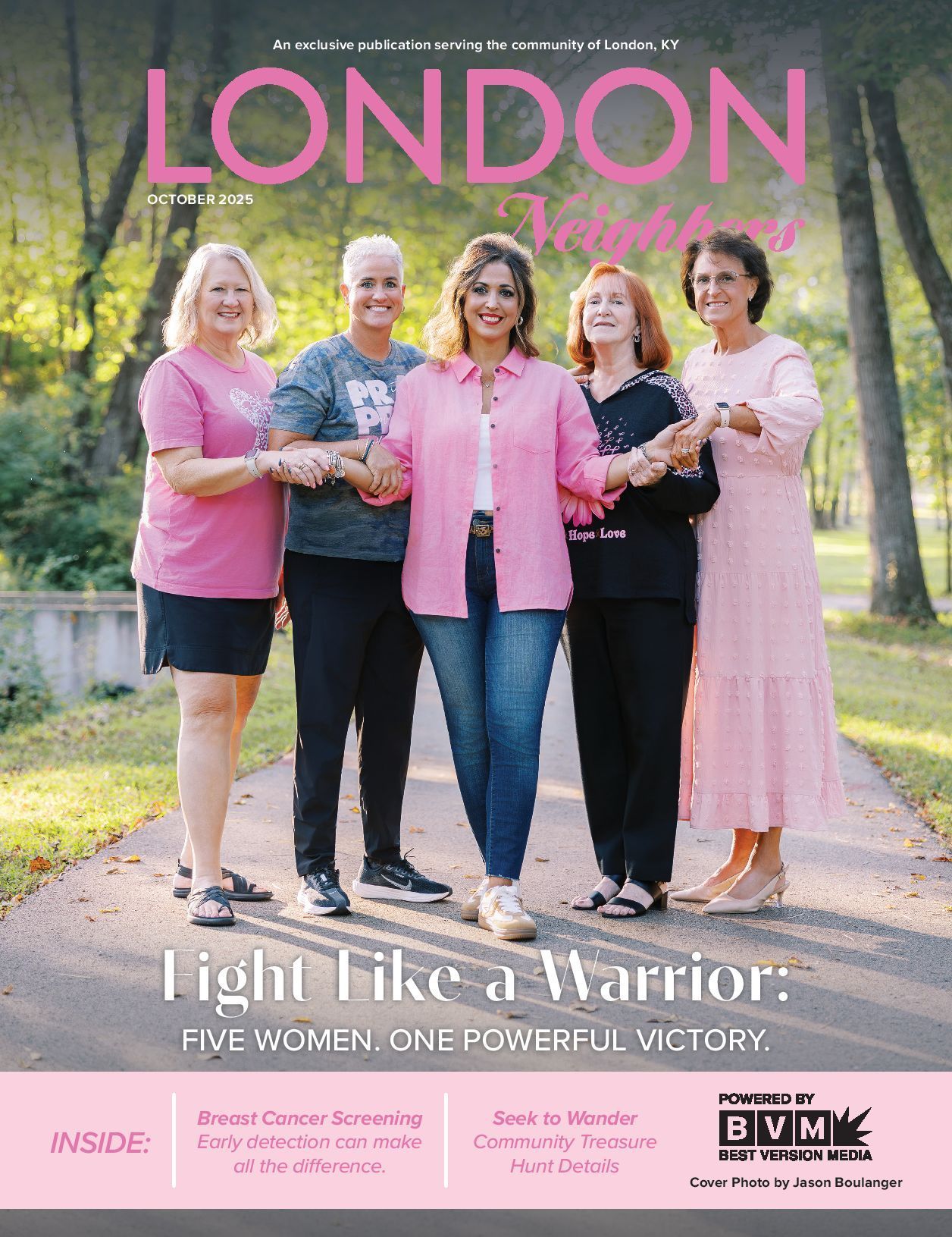 Five women in pink holding hands, standing on a path. 