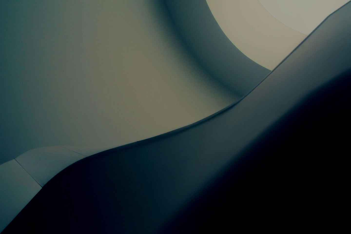 Abstract blue-gray geometric shapes with soft gradients and curved shadows