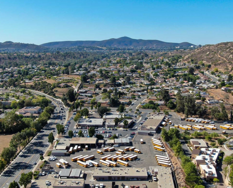 An aerial view of a city with mountains in the background.