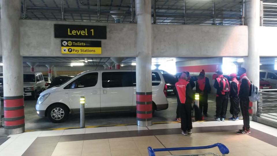 A white van is parked in level 1 of a parking garage