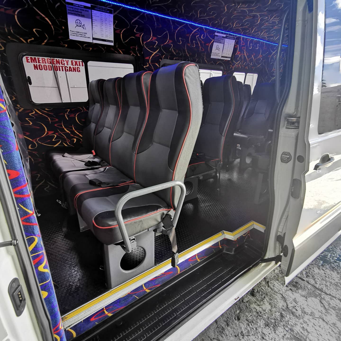 The inside of a van with a lot of seats and stairs.