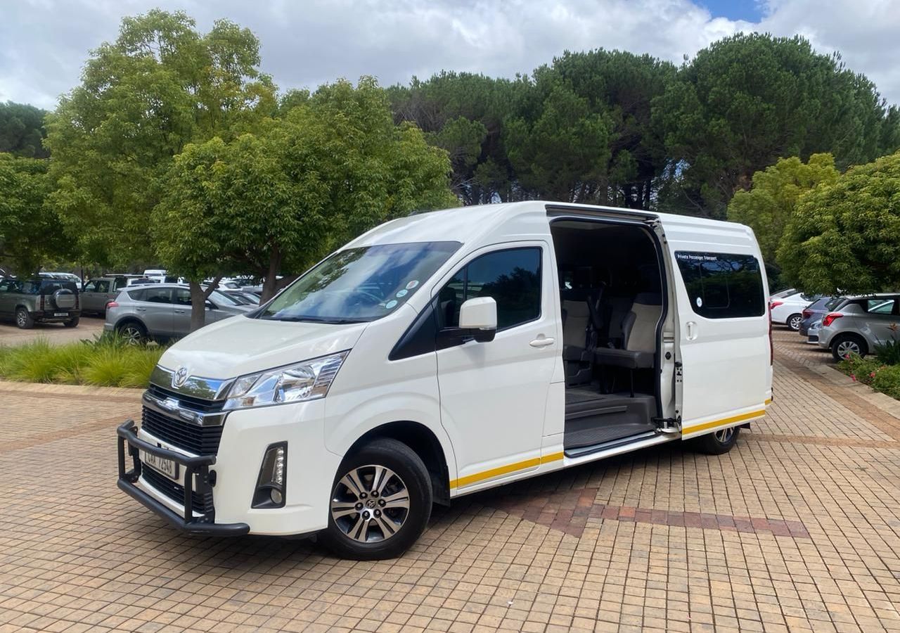 A white van is parked in a parking lot with its doors open.