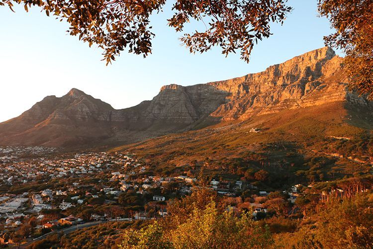 A view of a mountain range with a city in the foreground