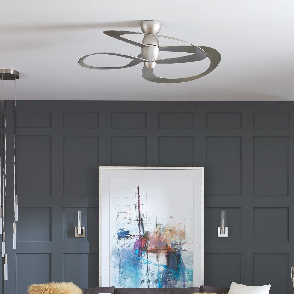 A living room with a ceiling fan and a painting on the wall