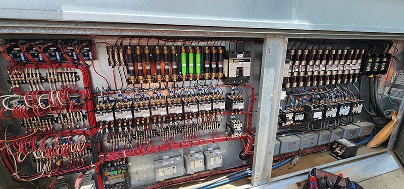 A large electrical box with a lot of wires coming out of it.