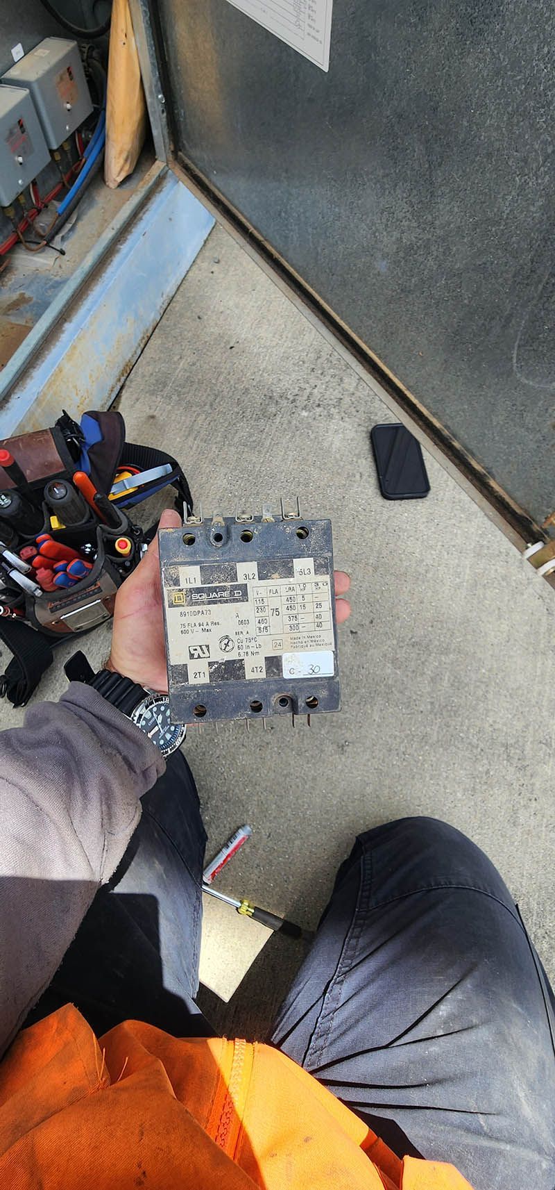 A person is holding a small electronic device in their hand.