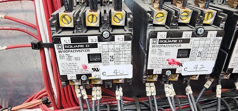 A close up of a bunch of electrical equipment on a wall.