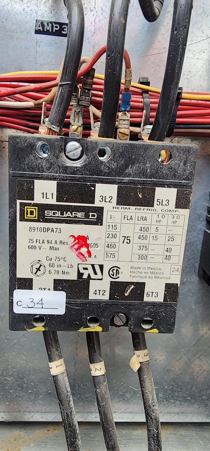 A close up of a electrical box with wires attached to it.