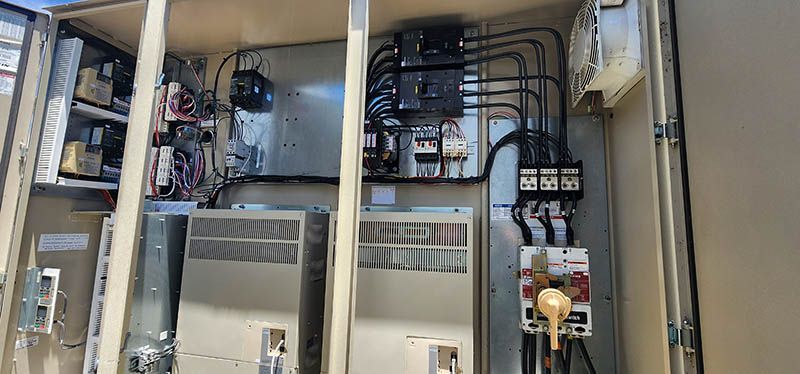 A large electrical box with a lot of wires coming out of it.