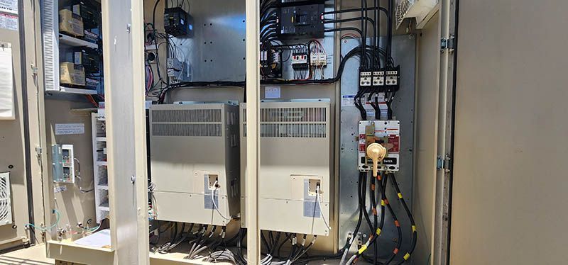 A large electrical box with a lot of wires coming out of it.