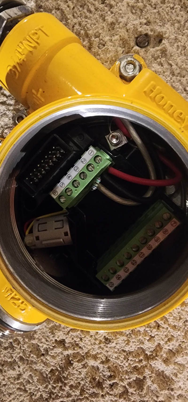 A yellow box with a bunch of wires inside of it.