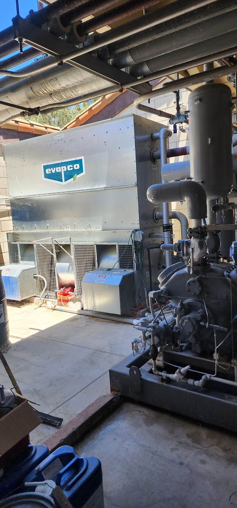 A room with a lot of pipes and a machine in it.