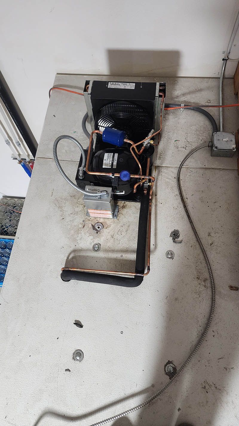 A machine is sitting on top of a counter next to a wall.