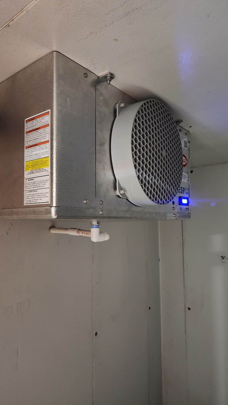 A fan is hanging from the ceiling of a room.