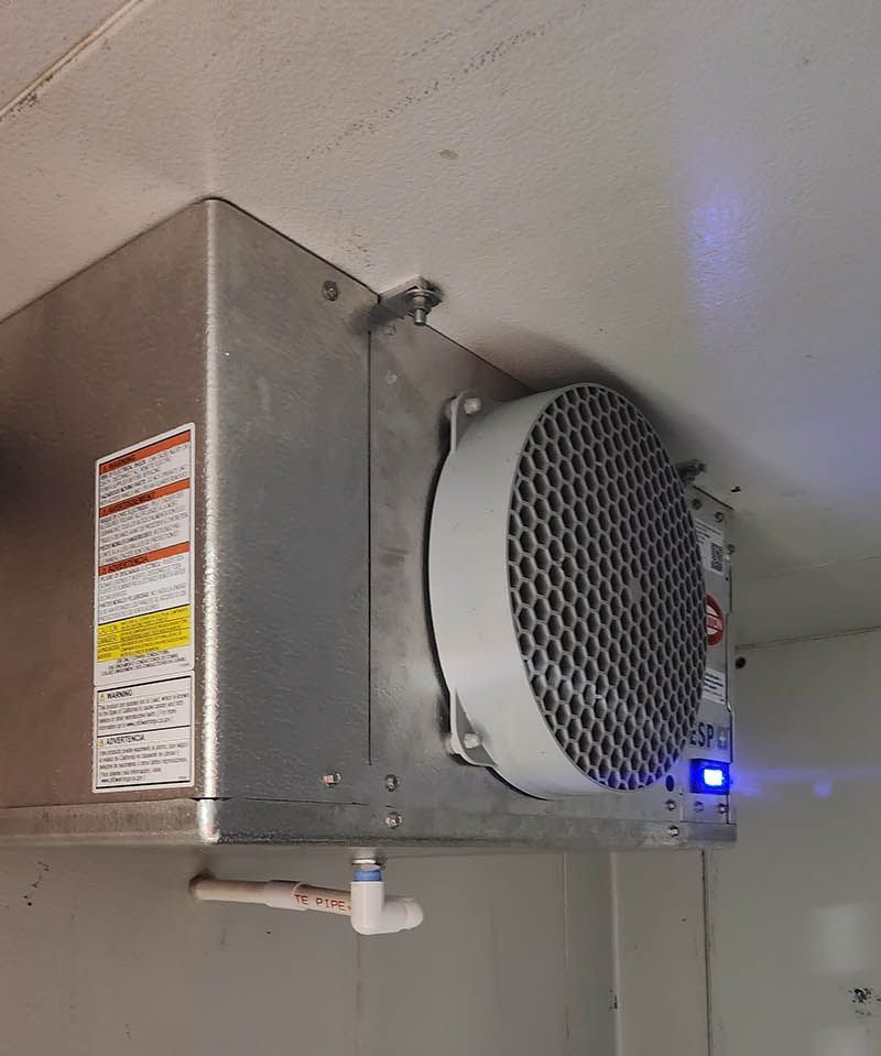 A stainless steel box with a fan attached to it