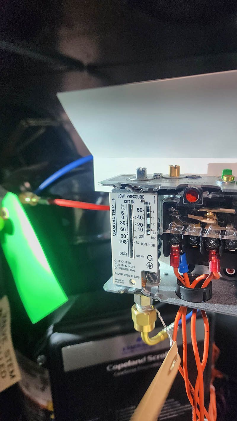 A close up of a fuse box with wires coming out of it.