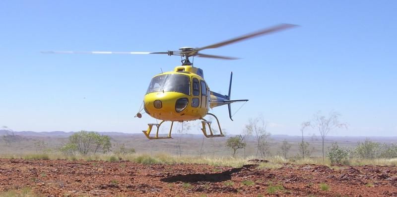 yellow color helicopter landing over the land