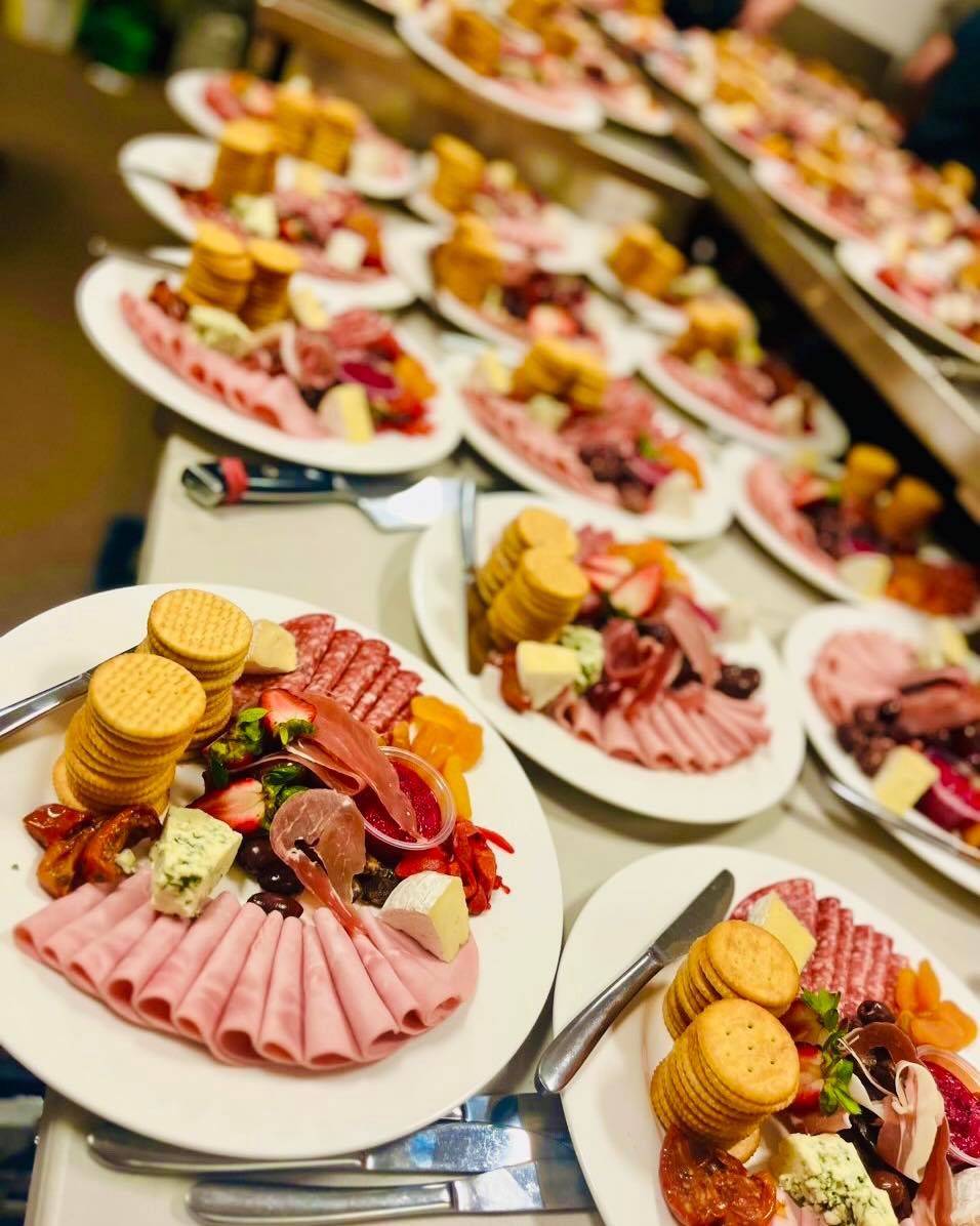A Table Topped with Plates of Food and Crackers — Every Occasion Catering in Moree, NSW