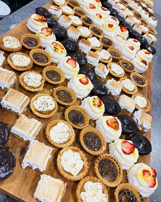 A Wooden Cutting Board Topped with A Variety of Desserts — Every Occasion Catering in Narrabri, NSW